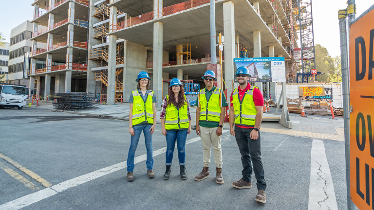 4 contractors standing in the street smiling to the camera